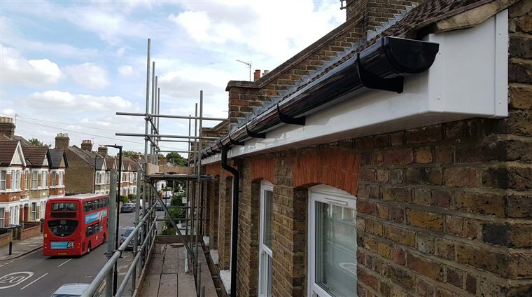 New black gutters and white fascias on a London terrace